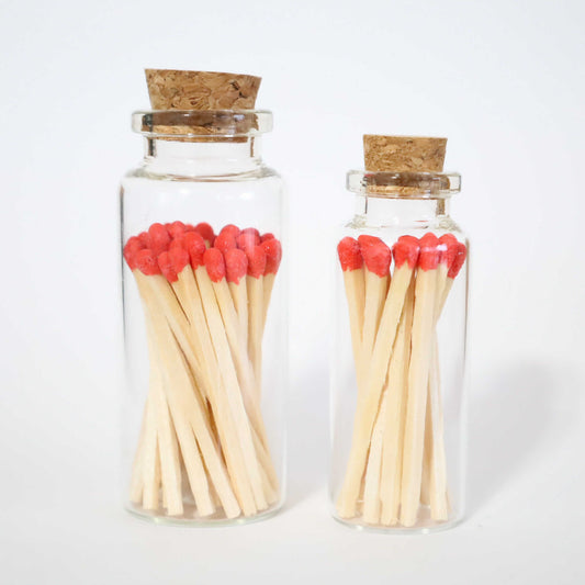 1 small glass bottle and 1 bigger glass bottle with cork cap with red tip safety matches inside
